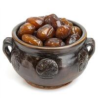 Sweet candied dates in a rustic brown ceramic bowl Delicious glazed fruit snacks photo