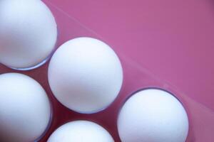 Minimalist composition White Eggs arranged on Vibrant Pink background, emphasizes Clean Lines and contrasts, culinary art, foodrelated concepts Diet Proteins Breakfast articles Easter themes photo