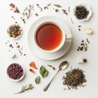 Top view of tea with spices and herbs on white background photo