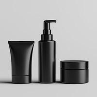 black cosmetic products on a grey background. photo