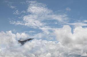 A jet flying through the clouds photo