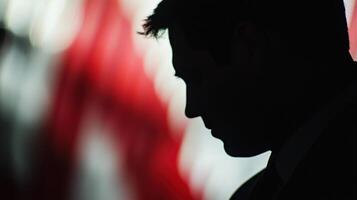 A closeup on a diplomats solemn expression revealing the weight of responsibility while the ethereal outoffocus layers of a national flag mural swirl behind signifying the importanc photo