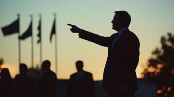 Politician giving a speech and pointing towards the future at sunset photo