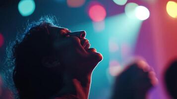 The leaders face is illuminated by the soft glow of vibrant lights filtering through a defocused backdrop capturing the intensity of their message as they inspire a sense of unity an photo