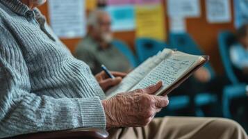 A closeup on the hands of an elderly man gripping a notepad with notes scribbled in the margins. His attentive gaze is directed at the speaker providing insight into the key concern photo
