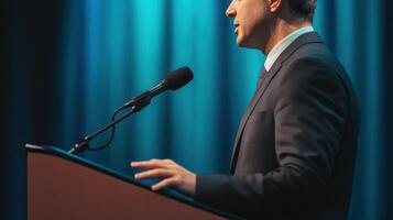 In a medium closeup a politician expresses determination while speaking passionately at a podium with an unwavering gaze. The background is a gradient of rich blue tones giving an photo