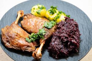 fried duck legs with cabbage photo
