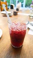 A glass of red berry juice that looks refreshing and delicious photo