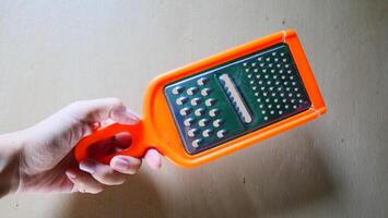 A handheld tool for peeling and slicing fruit photo