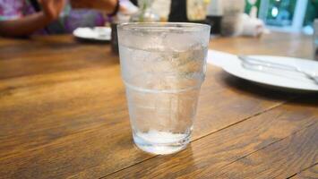A clear glass filled with ice gives a refreshing and cool feeling photo