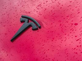 Lviv Ukraine 23.03.25 Red car covered in raindrops with logo detail photo