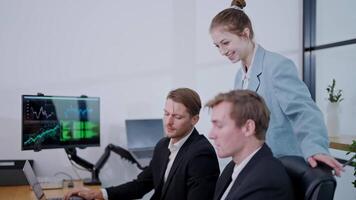 Business meeting with team discussing project in modern office while analyzing data on computers video