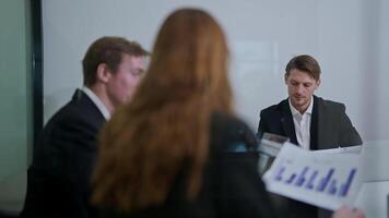Business meeting in a modern office with professionals discussing growth strategies and analyzing data charts video