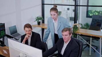 Colleagues collaborating on a project in a modern office environment in the afternoon video