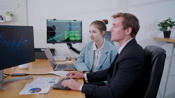 Professionals analyzing data trends in a modern office environment during work hours video