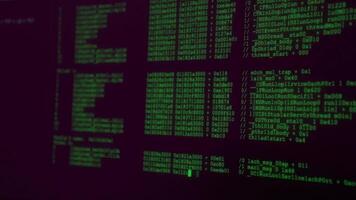 Coding session with dual monitors displaying programming data in a vibrant workspace during evening hours video