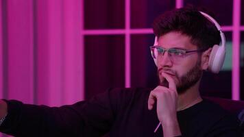 A focused individual analyzes data on dual monitors in a cozy home environment, illuminated by vibrant ambient lights, creating a productive. video