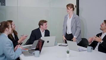 Team members engage in a productive meeting discussing project updates and strategies at a modern office video