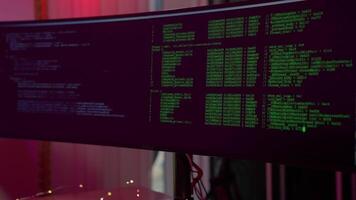 Coding session with dual monitors displaying programming data in a vibrant workspace evening hours video