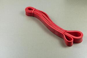 Red rubber band arranged neatly on a flat surface photo
