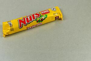 Lviv Ukraine 04.02.25 Colorful candy wrapper on a gray surface in a studio photo