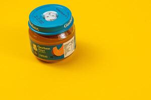 Lviv Ukraine 04.02.25 Baby food jar on a bright yellow background photo