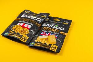 Lviv Ukraine 04.02.25 Snacks displayed on vibrant yellow background photo