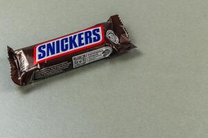 Lviv Ukraine 04.02.25 Chocolate bar placed on a gray background in daytime photo