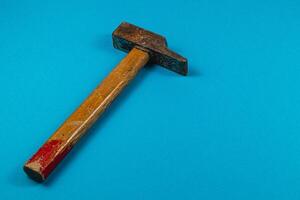 Tool resting on blue surface in a workshop setting photo