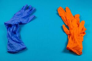 Colorful rubber gloves on a blue background photo