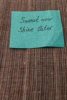 Motivational note placed on fabric reminds to work hard for future success photo