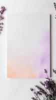 Lavender flowers and a blank white paper on a white background photo