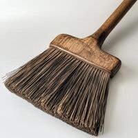 A broom with a wooden handle and a black handle photo
