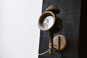 Antique Wall Lantern Fixed to Stone Surface photo