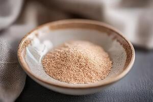 Psyllium husk in a bowl on a textured surface photo