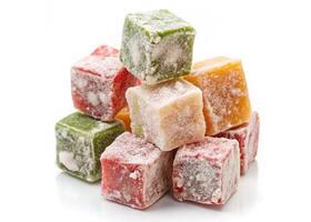 Several colorful cubes of gummy bears on a white background photo