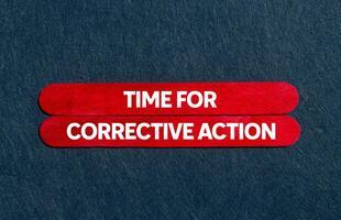 Time for corrective action message written on red wooden sticks on gray background. Conceptual time for corrective action symbol. Copy space. photo