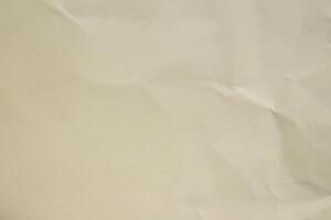 Crumpled or creased paper as background creased craft paper texture design element blank paper sheet photo