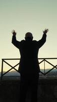 Silhouette Of An Old Man Greeting Happy With Hand From The Panoramic View Of The City video