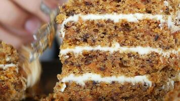 Carrot cake layers being sliced and served at a gathering video