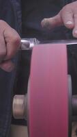 Craftsman sharpening a knife with precision at a workshop video