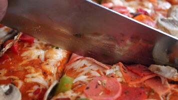 Slicing delicious pizza in a cozy kitchen setting video