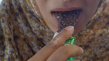 Enjoying a chocolate snack during a sunny day at the local market video