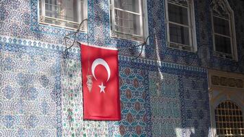 turkey istanbul 23 june 2024. Colorful tile patterns and a flag near Ottoman architecture in Turkey video