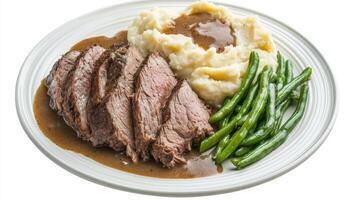 Savory beef roast with creamy mashed potatoes and vibrant green beans served on a festive dinner plate photo