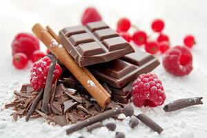 Chocolate with raspberries and cinnamon on white photo