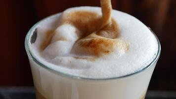 Preparing a creamy coffee beverage with frothy texture and aroma video