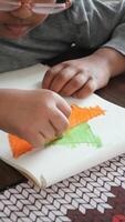 Child creating colorful art using crayons on paper video