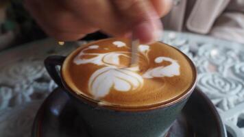 Creating beautiful latte art in a cozy cafe video