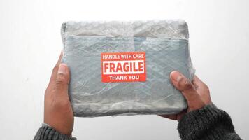 Unboxing a fragile package with careful handling techniques video